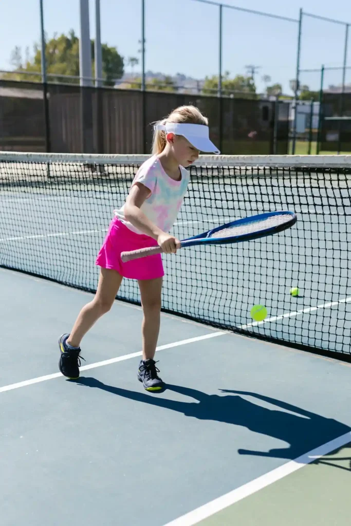 A girl playing in UK Tennis Club with a racquet in her hand